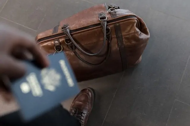 Immigrant Adaptation in 2026 2 Person walking with passport. Immigrants adapting to new cultures often have a hard time understanding some local customs.