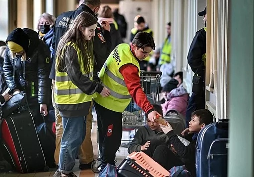 Volunteers helping asylum seekers in the Przemyśl train station, Poland.