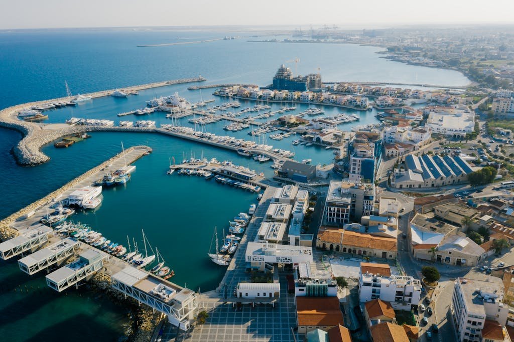 Stunning aerial view of Limassol Marina, Cyprus featuring yachts and urban landscape.