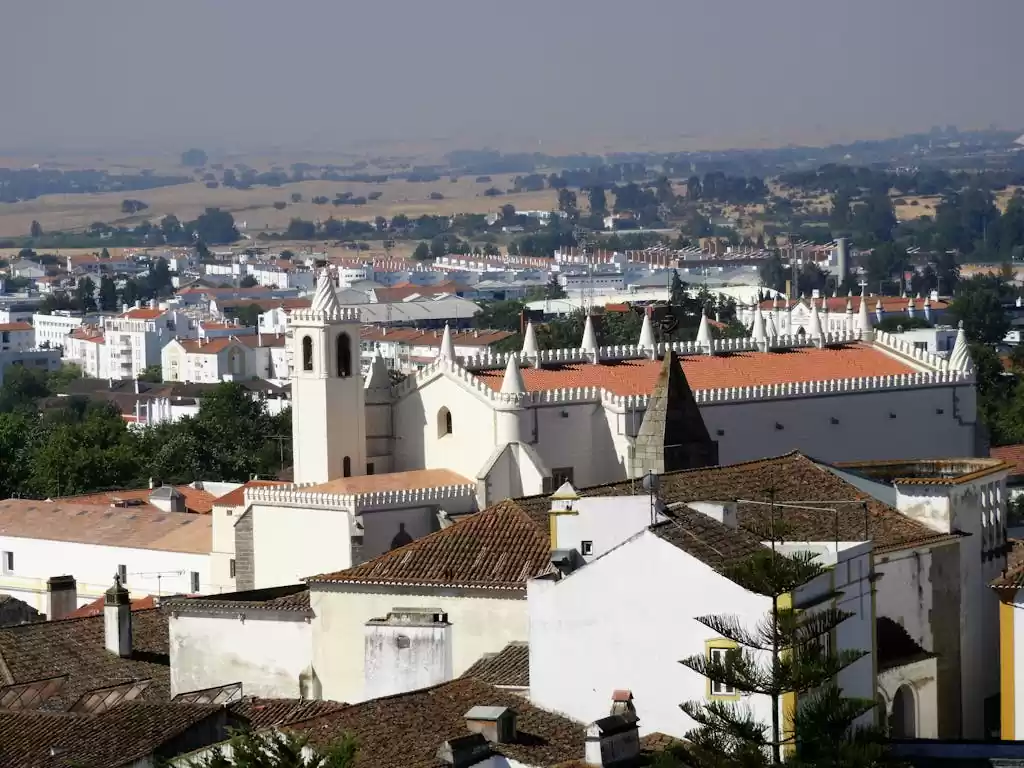 Stunning aerial view of Évora, showcasing historic architecture surrounded by a beautiful landscape.