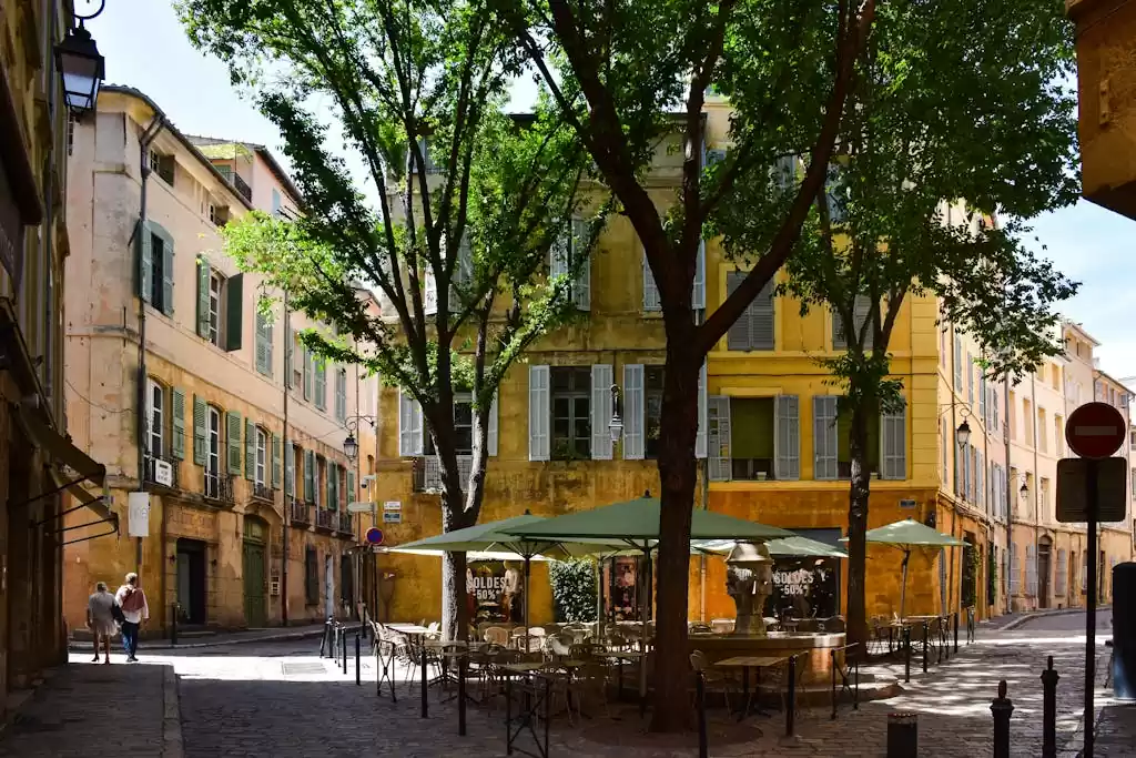 Picturesque street corner in Aix-en-Provence, showcasing traditional architecture and vibrant outdoor café setting.