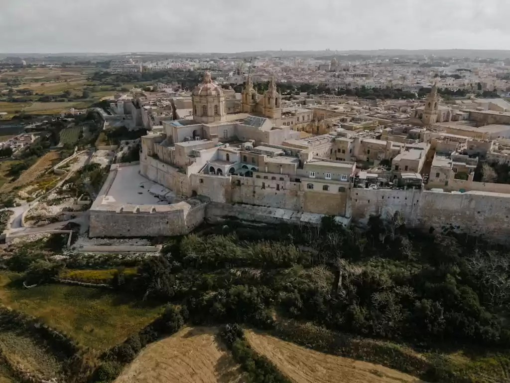 Stunning aerial shot of the ancient fortified city of Mdina in Malta, showcasing its historic architecture.
