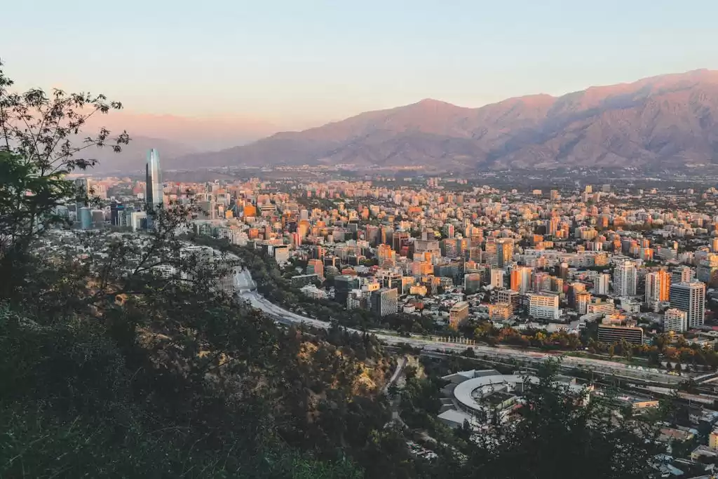 Breathtaking view of Santiago, Chile's skyline framed by mountains at sunset. Not One of the Best Cities to Retire in Chile