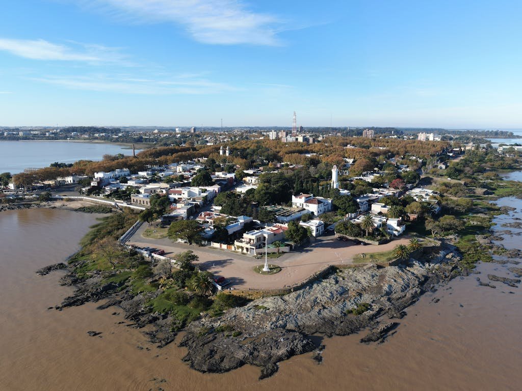 A scenic aerial view of Colonia Del Sacramento's coastline capturing its historical charm and natural beauty.