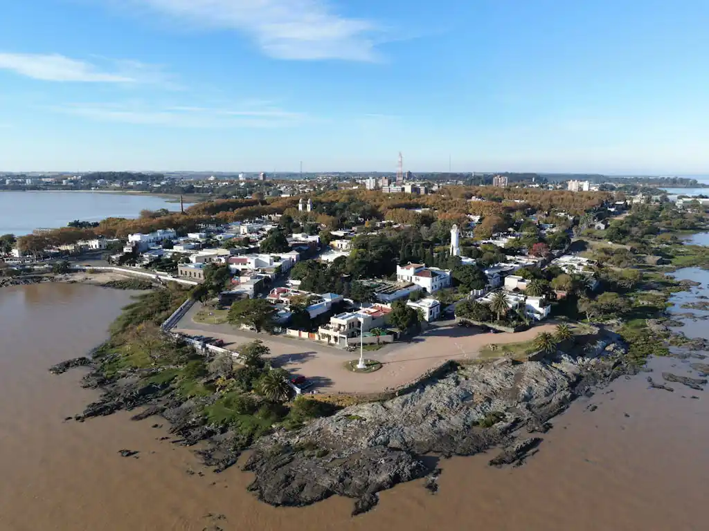 The 5 Best Cities to Retire in Uruguay | Cost of Living & Where 10 A scenic aerial view of Colonia Del Sacramento's coastline capturing its historical charm and natural beauty.
