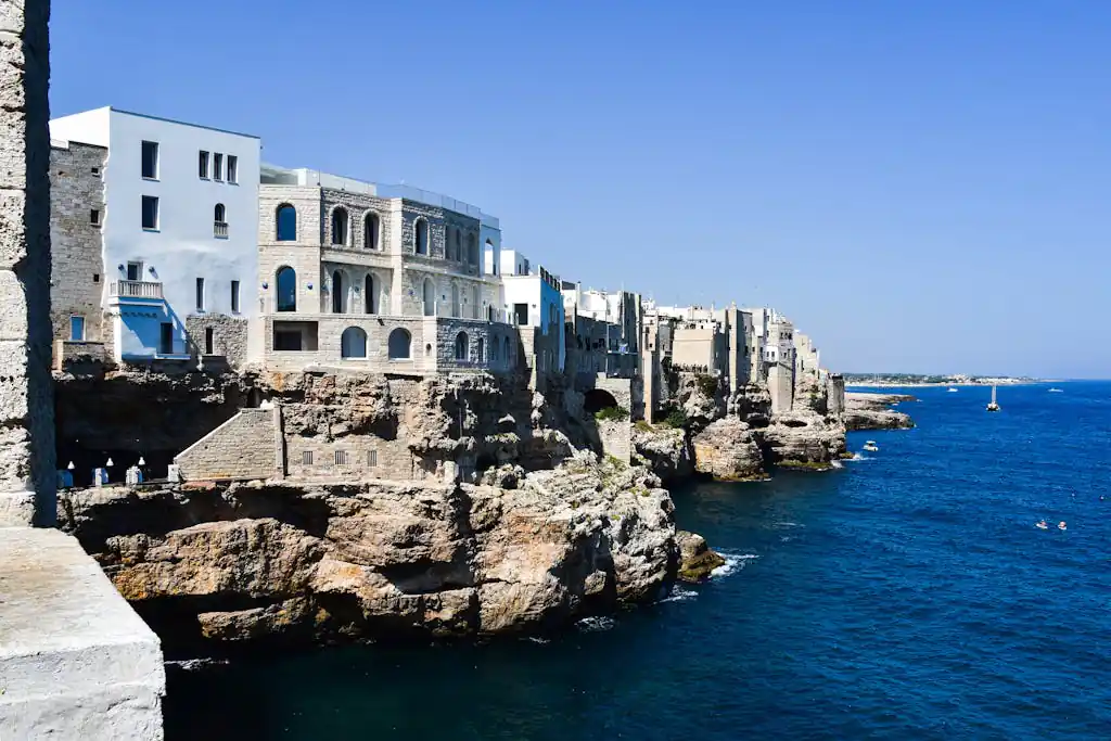 Beautiful cliffside view of Polignano a Mare, Italy with blue sea and sky.