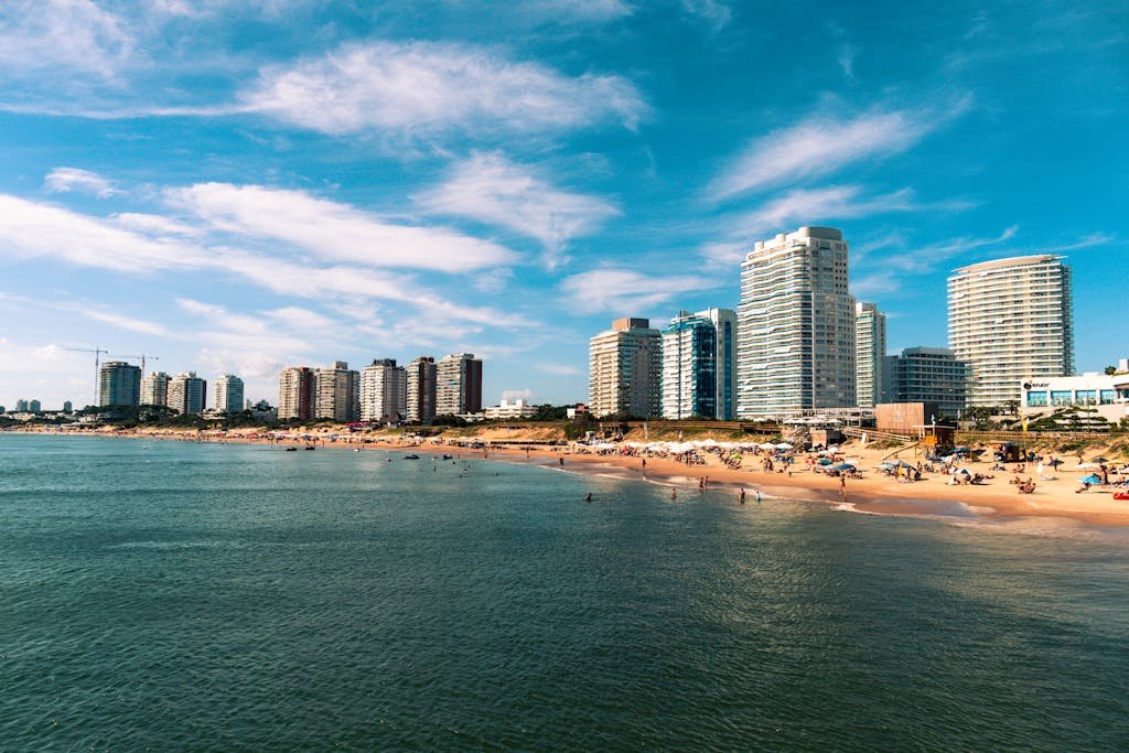 Explore Punta del Este's beautiful beachfront cityscape with blue waters and vibrant life.