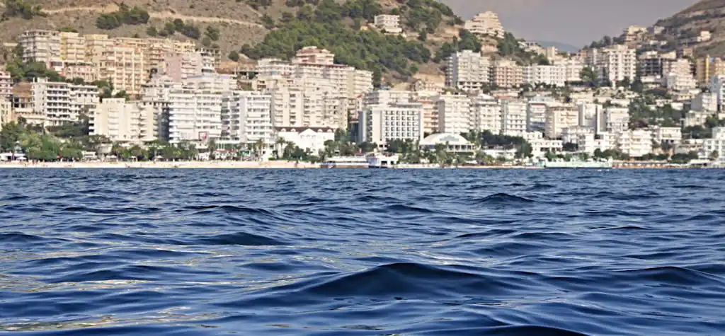 Beautiful view of the Sarandë waterfront with buildings along the seashore.